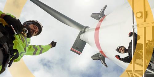 men working under a wind turbine